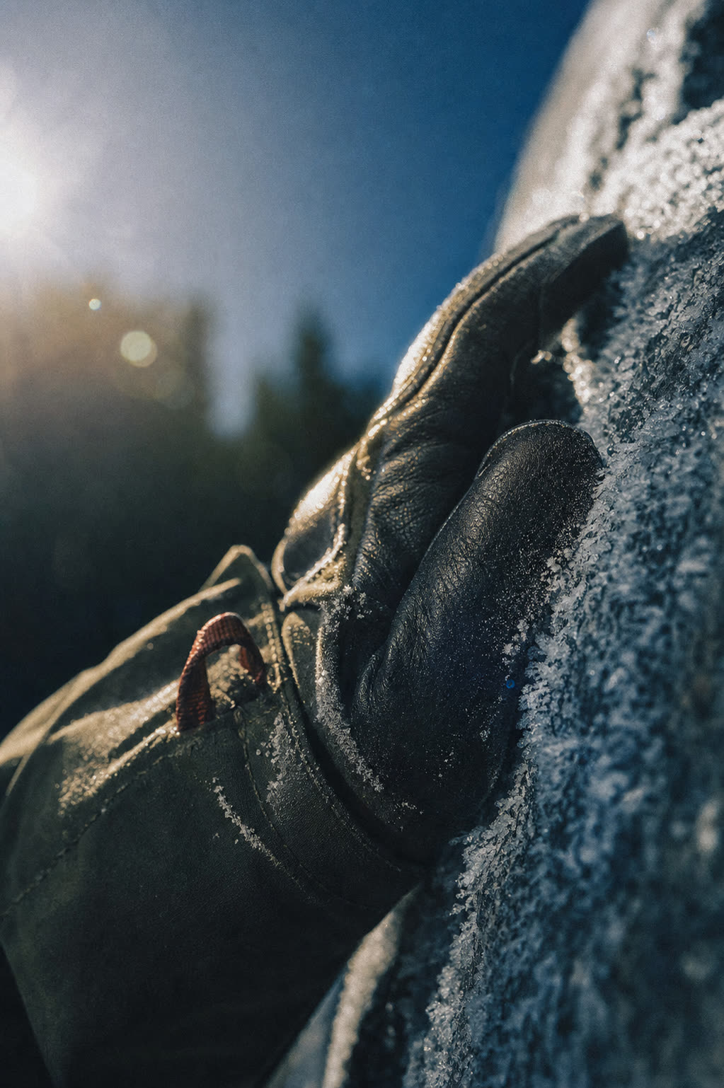 Frost-crusted glove resting on snow